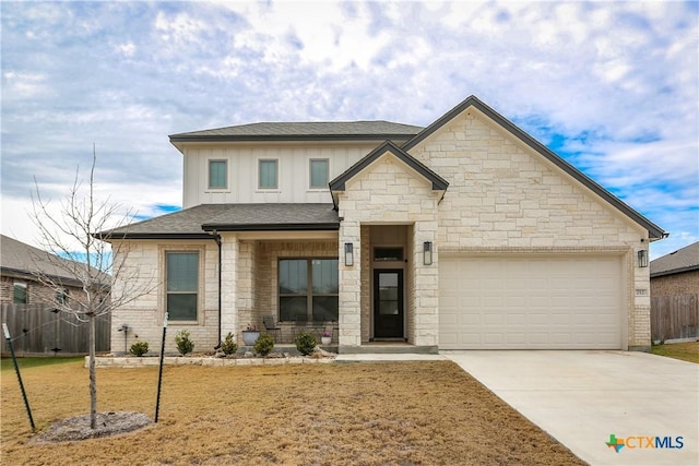 view of front of home featuring a garage and a front yard