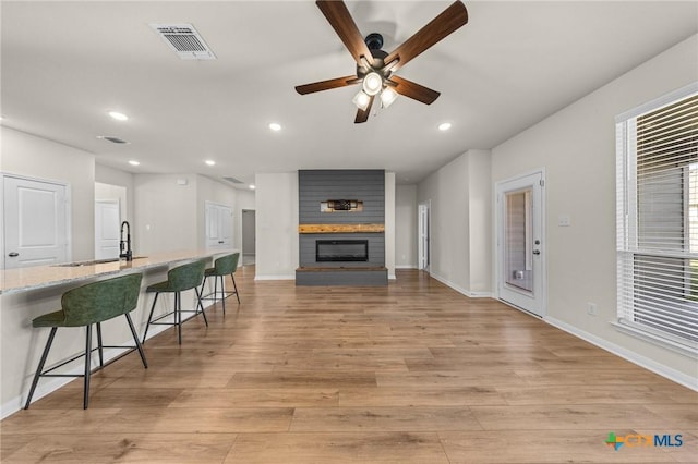 1821 Holleman Dr, Temple, TX 76502 - living area featuring ceiling fan, recessed lighting, light wood finished floors, and a fireplace