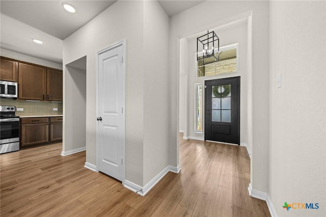 1821 Holleman Dr, Temple, TX 76502 - foyer entrance with light wood-style flooring, a chandelier, and recessed lighting