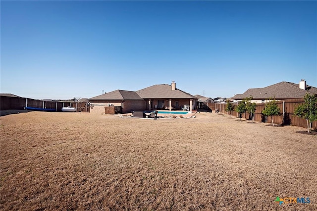 view of yard with a fenced in pool, a patio, and a fenced backyard