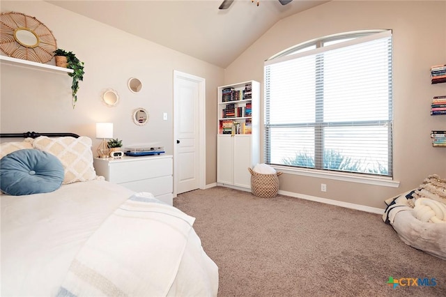 bedroom featuring multiple windows, light carpet, baseboards, and vaulted ceiling