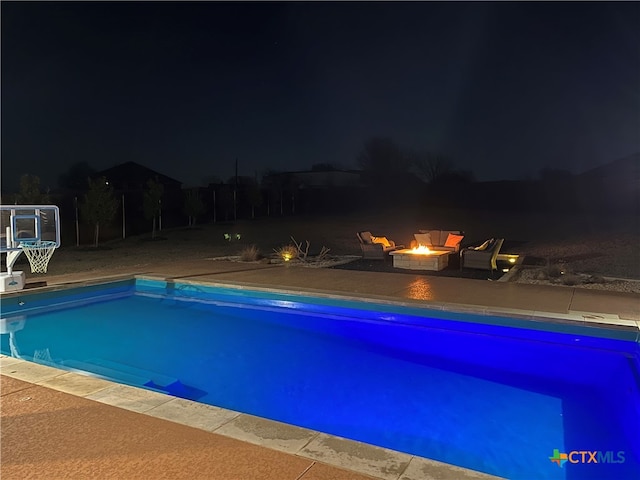 pool at twilight with a fire pit