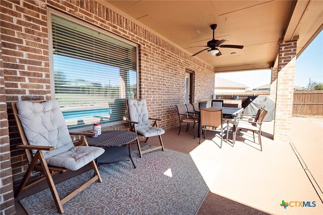 view of patio / terrace with outdoor dining space, a ceiling fan, and fence