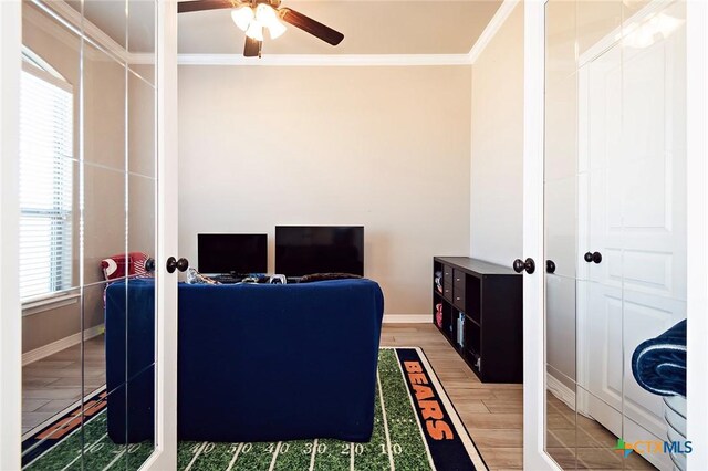 home office featuring baseboards, wood finished floors, a ceiling fan, and ornamental molding