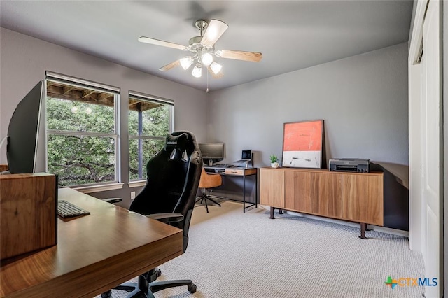 home office with light colored carpet and a ceiling fan