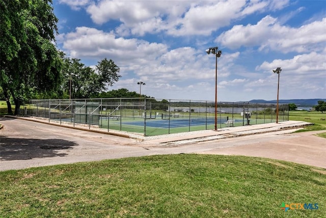 surrounding community with a tennis court