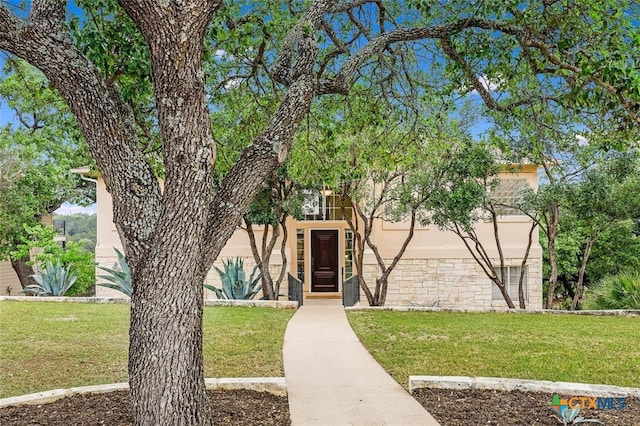view of front of property with a front lawn and stucco siding