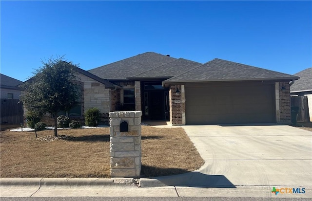 view of front of property with a garage and a front lawn