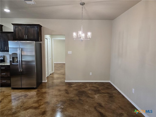 1421 Fossil Trl, Belton, TX 76513 - kitchen with stainless steel refrigerator with ice dispenser, finished concrete flooring, baseboards, a chandelier, and dark brown cabinetry