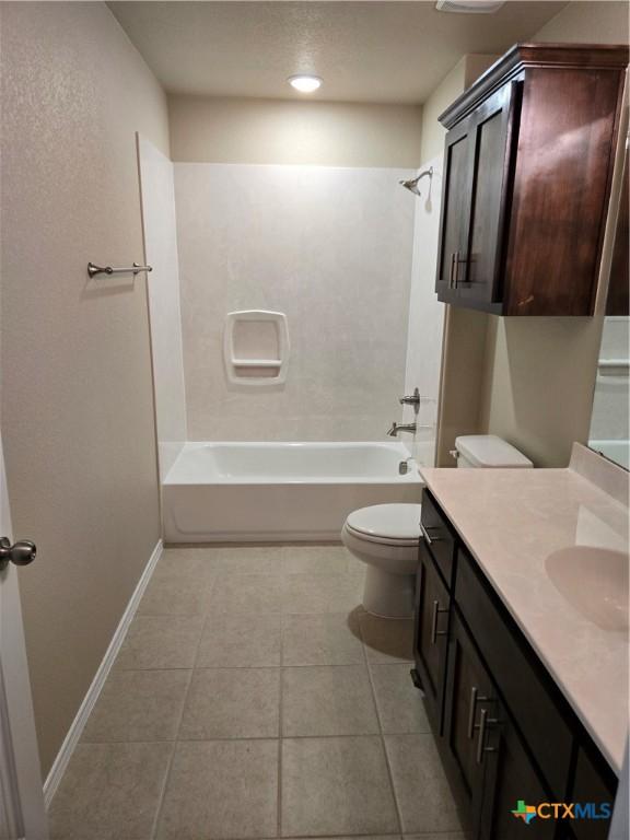 1421 Fossil Trl, Belton, TX 76513 - bathroom featuring toilet, tile patterned floors, vanity, shower / washtub combination, and baseboards