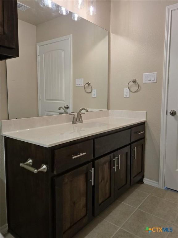 1421 Fossil Trl, Belton, TX 76513 - bathroom with tile patterned floors, vanity, and baseboards