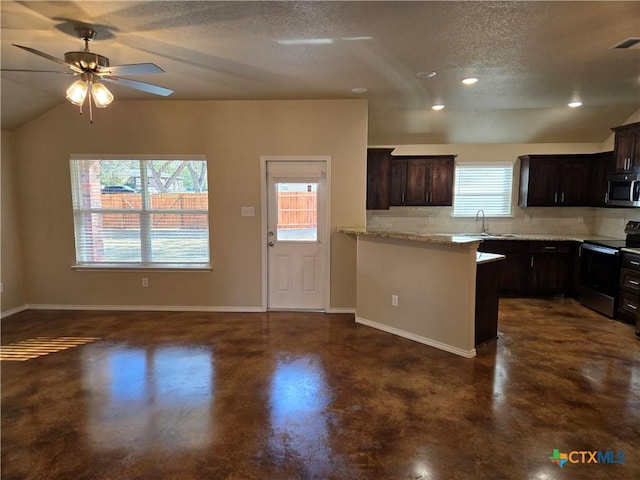1421 Fossil Trl, Belton, TX 76513 - kitchen with stainless steel appliances, finished concrete flooring, a textured ceiling, a peninsula, and baseboards