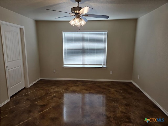 1421 Fossil Trl, Belton, TX 76513 - spare room featuring concrete flooring, a ceiling fan, and baseboards