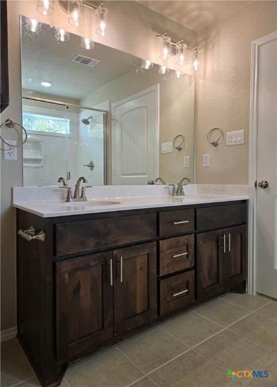 1421 Fossil Trl, Belton, TX 76513 - bathroom with tile patterned floors, a shower stall, and double vanity