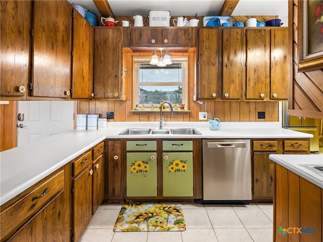 kitchen featuring stainless steel dishwasher, sink, and light tile patterned floors