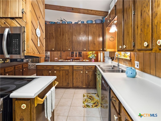 kitchen featuring appliances with stainless steel finishes, sink, and light tile patterned floors