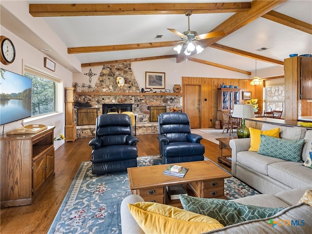 living room featuring lofted ceiling with beams, ceiling fan, a fireplace, and dark hardwood / wood-style flooring