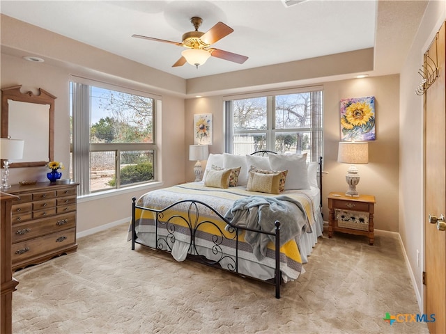 bedroom featuring light colored carpet and ceiling fan