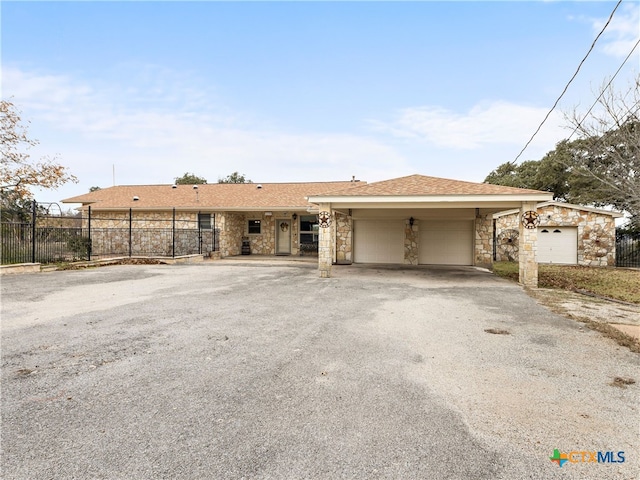 ranch-style house with a garage and a carport