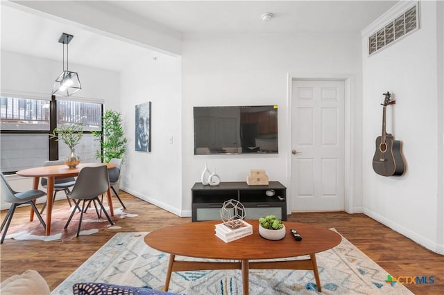 2502 Leon St Unit 201, Austin, TX 78705 - living area with baseboards, visible vents, and wood finished floors