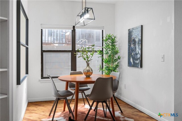 2502 Leon St Unit 201, Austin, TX 78705 - dining space with baseboards and wood finished floors