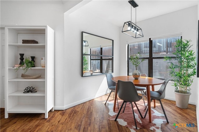 2502 Leon St Unit 201, Austin, TX 78705 - dining space with a healthy amount of sunlight, baseboards, and wood finished floors