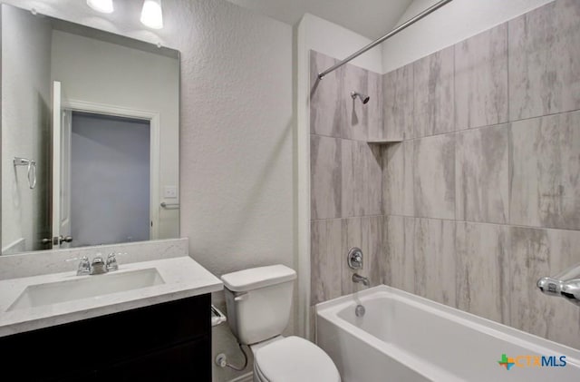 bathroom featuring shower / bath combination, toilet, vanity, and a textured wall