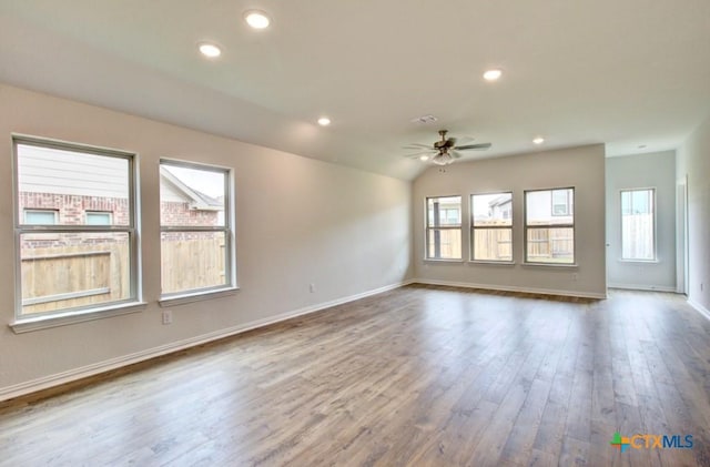 unfurnished living room with baseboards, wood finished floors, recessed lighting, and a ceiling fan