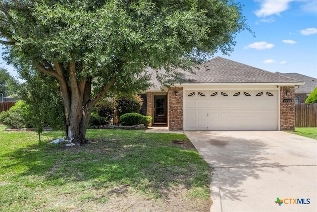 2903 Tucson Dr, Killeen, TX 76543 - view of front of home featuring brick siding, a garage, driveway, and a shingled roof