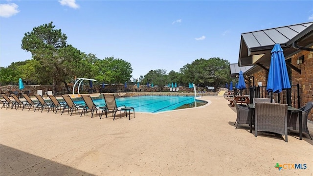 community pool featuring a patio and fence