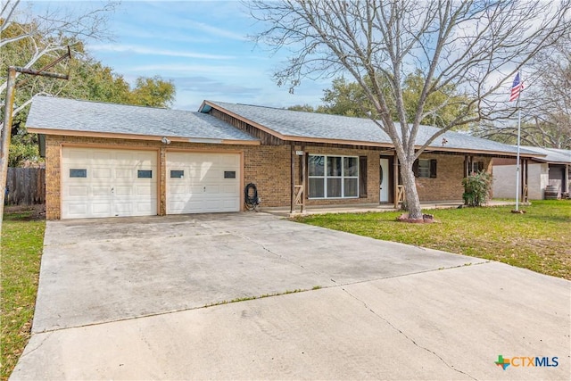 ranch-style house featuring brick siding, fence, concrete driveway, a front yard, and an attached garage