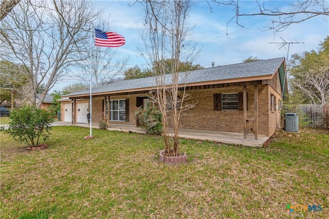 view of front of home featuring brick siding, a front yard, roof with shingles, cooling unit, and an attached garage