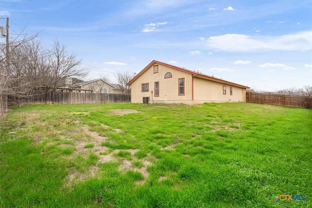 rear view of house featuring a yard