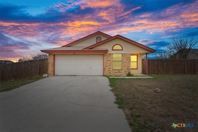 single story home with a lawn and a garage