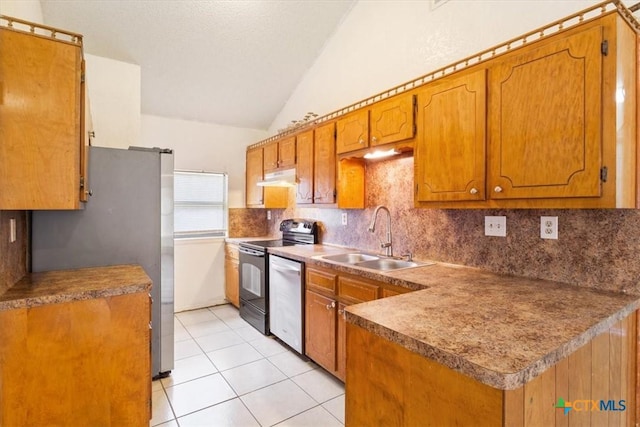 kitchen with lofted ceiling, backsplash, sink, light tile patterned floors, and stainless steel appliances