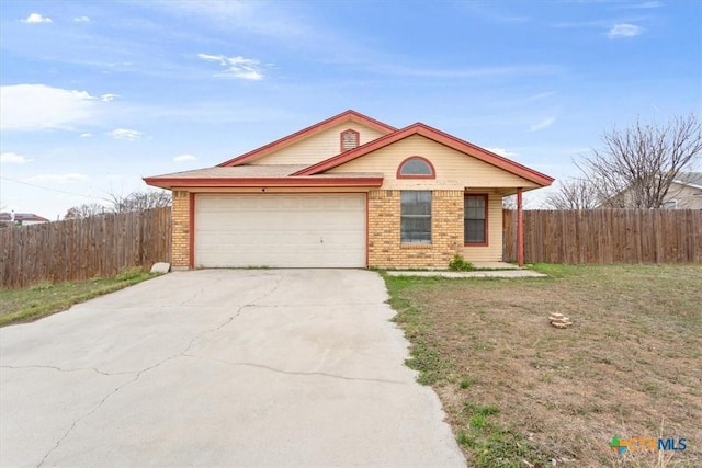 ranch-style house featuring a garage and a front lawn