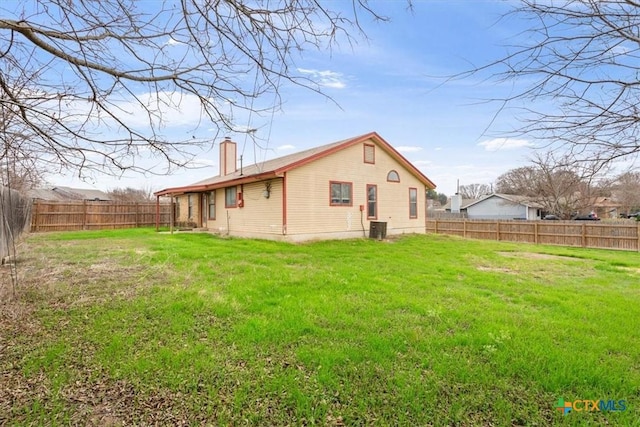 back of house featuring a yard and central air condition unit