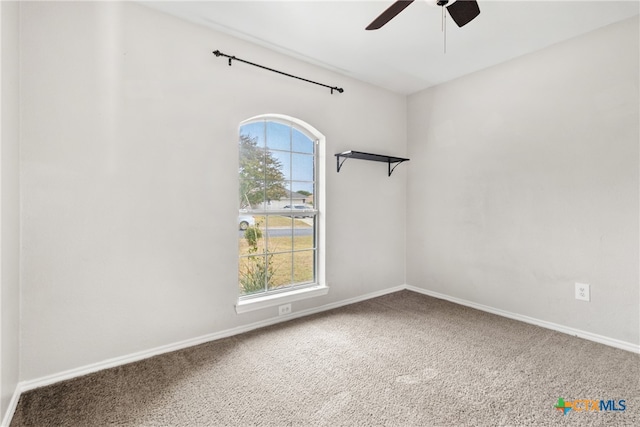 unfurnished room with ceiling fan, plenty of natural light, and carpet