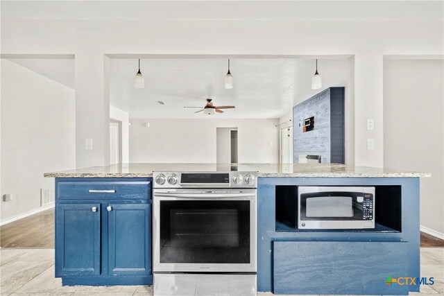 kitchen with blue cabinetry, light stone counters, stainless steel appliances, and hanging light fixtures