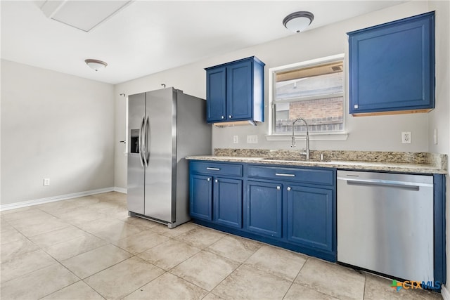 kitchen with blue cabinetry, sink, light tile patterned floors, and stainless steel appliances