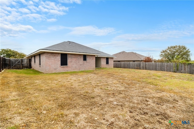 rear view of house with a yard