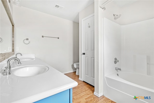 full bathroom with vanity, toilet, shower / bathing tub combination, and hardwood / wood-style flooring