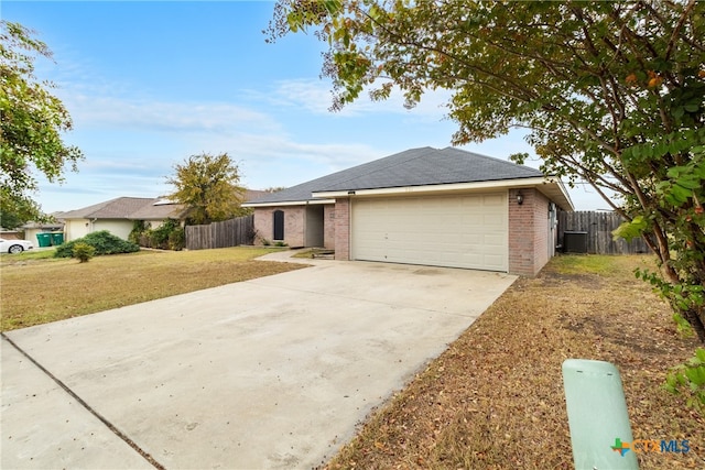 single story home with central AC unit, a garage, and a front yard