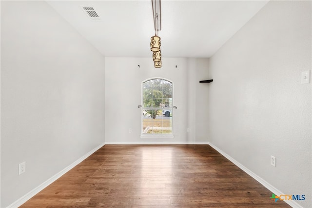 spare room with hardwood / wood-style floors