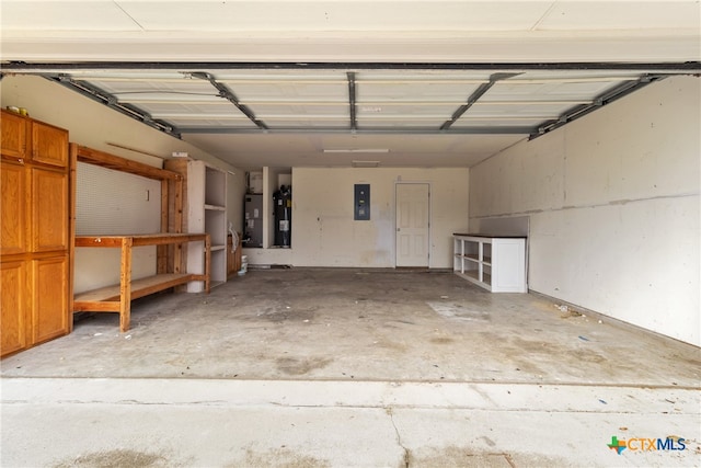 garage with electric panel and water heater