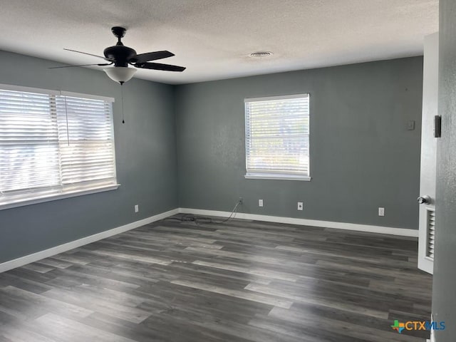 empty room with a textured ceiling, ceiling fan, and dark wood-type flooring