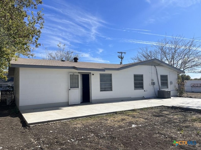 rear view of property with central AC unit and a patio