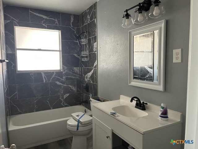 full bathroom with vanity, toilet, and tiled shower / bath