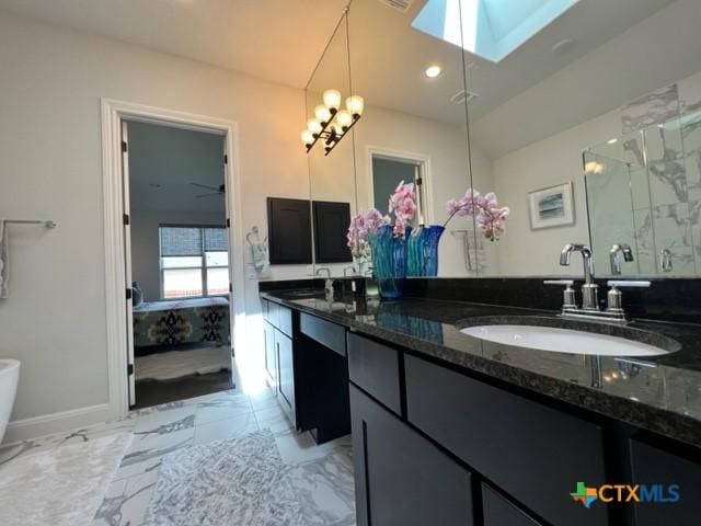 4201 Arques Ave, Round Rock, TX 78681 - bathroom with a skylight, double vanity, a marble finish shower, and marble finish flooring