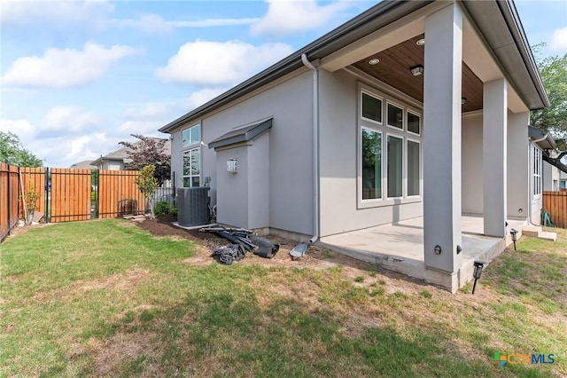 4201 Arques Ave, Round Rock, TX 78681 - view of side of home featuring cooling unit, stucco siding, and a patio